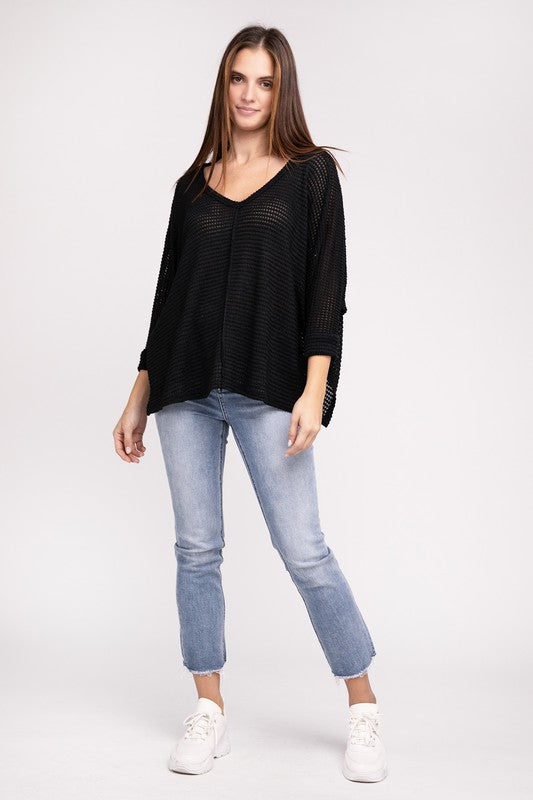 Model wearing a black 3/4 sleeve V-neck hi-low hem Jacquard sweater with light blue jeans.