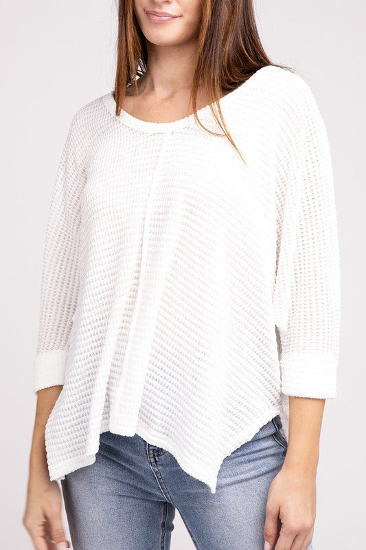 Model wearing a white 3/4 sleeve hi-low hem jacquard sweater with a casual style.